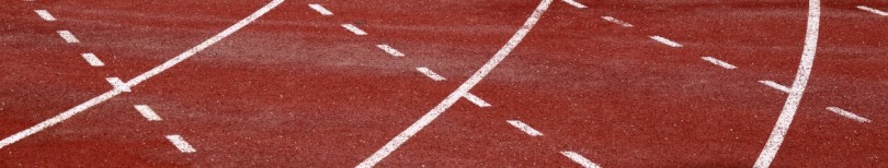 a red athletics track with white lane markings